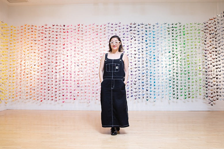 Heidi Moon Matsukawa with display of origami cranes at the Arts Council